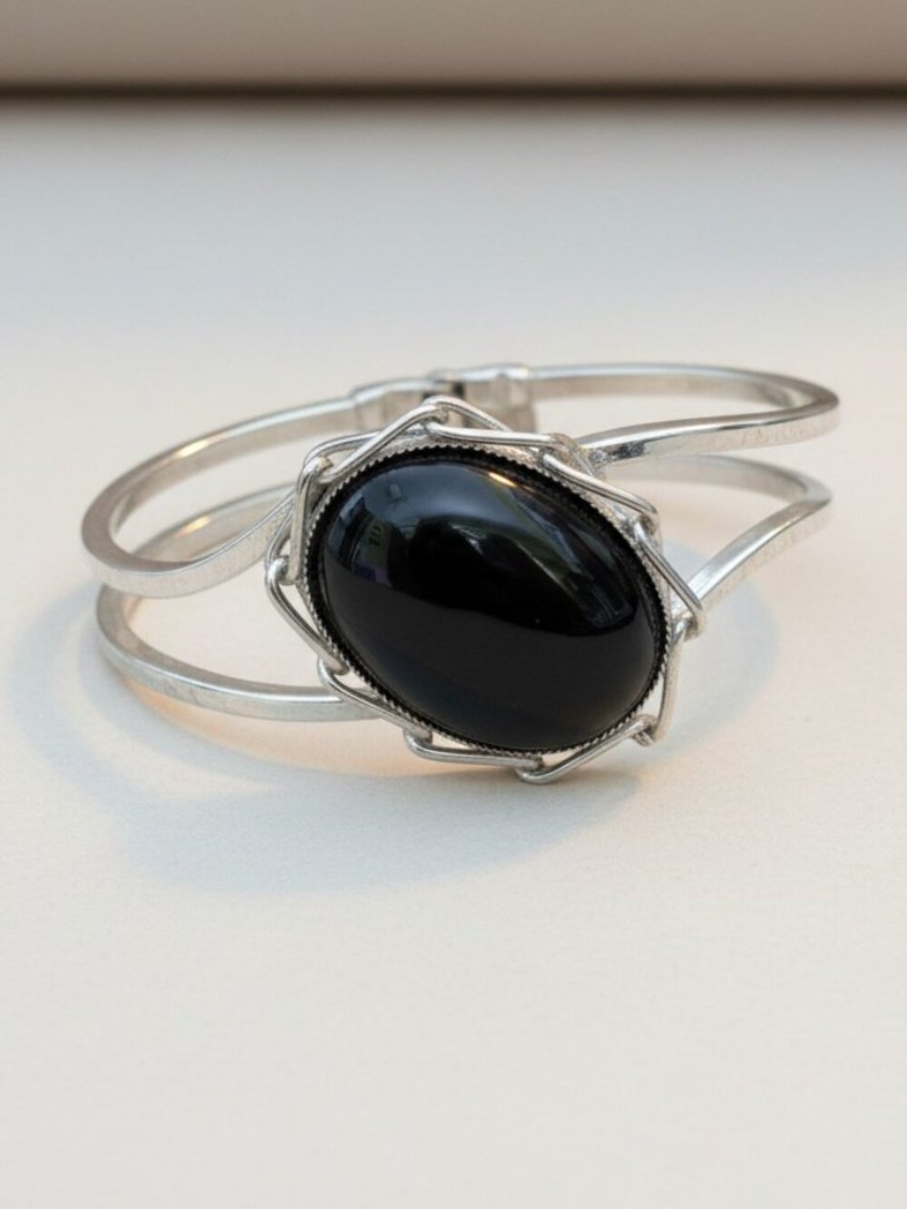 Silver toned hinged cuff bracelet with Onyx-like stone